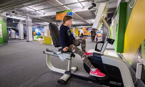 Child playing on calorie bike at Aberdeen science centre