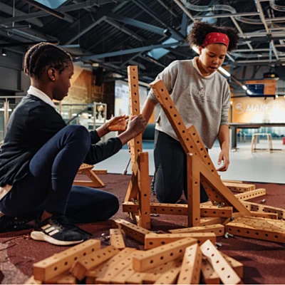 Two school pupils building a structure at Aberdeen Science Centre